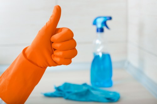 Trained cleaner using protective gloves during carpet cleaning